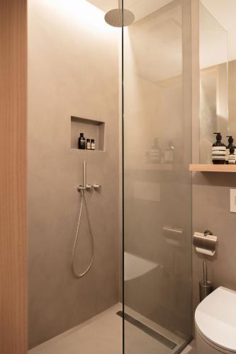 a shower with a glass door in a bathroom at Schgaguler Hotel in Castelrotto