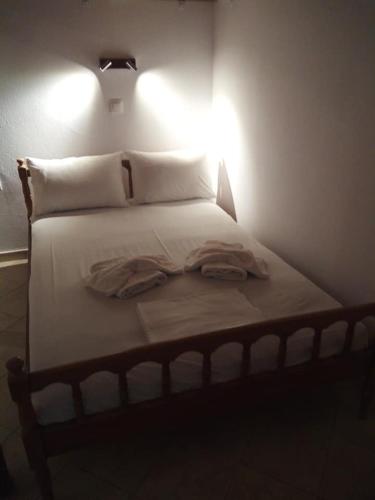 a bedroom with a bed with a light on it at Beachfront Apartment Kato Zakros in Káto Zákros