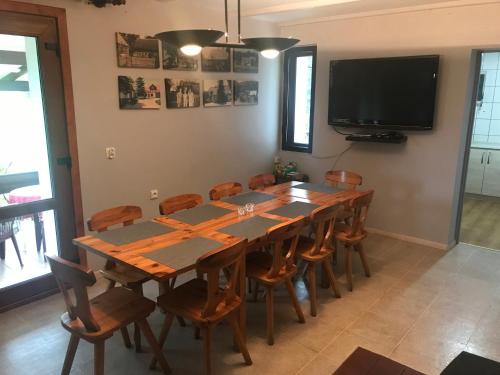 a dining room with a large wooden table and chairs at Gościniec Boruja in Bytów