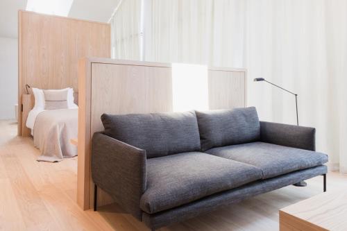 a living room with a couch and a bed at Schgaguler Hotel in Castelrotto