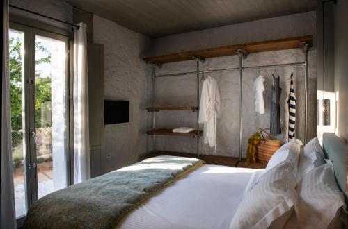 a bedroom with a large white bed and a window at Villa Vivere in Asos