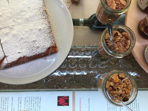 a table with a plate of food and a cake at winebnb in Sondrio
