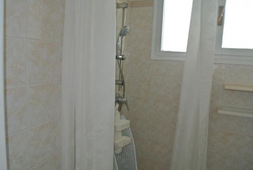 a bathroom with a shower with a shower curtain at Appartamento CRISTALLO 25 in Lignano Sabbiadoro