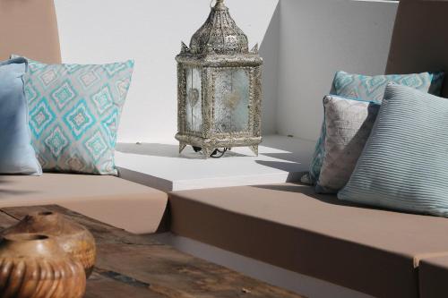 a living room with a couch and a table with pillows at B&B Casa Luz del Sur, adults only in Alhaurín el Grande