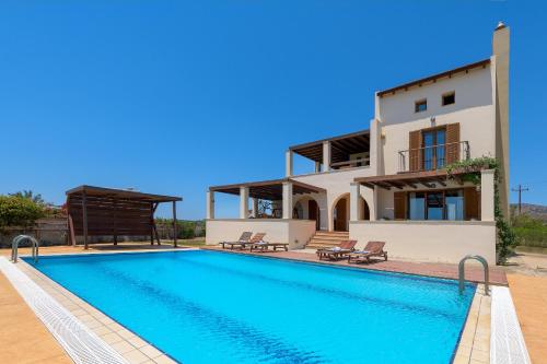 a villa with a swimming pool and a house at Villa Lahania in Lachania