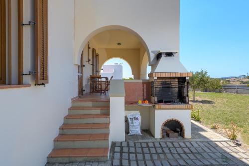 a house with an outdoor oven on the side of it at Villa Lahania in Lachania