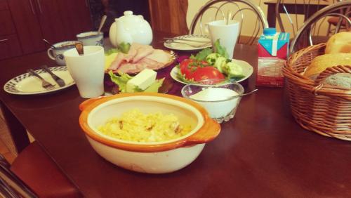 a table with a bowl of food on a table at Noclegi U Dyncyka in Krajno Pierwsze
