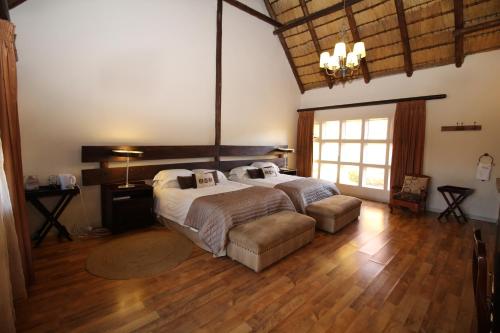 a large bedroom with two beds and a large window at Oak Park and Conference Centre in Kokstad