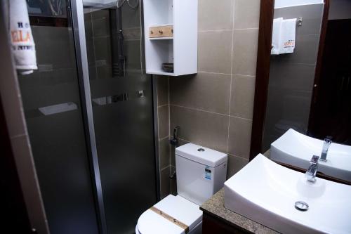 a bathroom with a toilet and a sink and a shower at Hotel Bella Vista in Anuradhapura