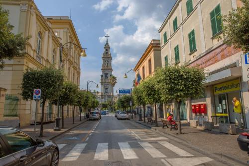 a city street with a clock tower in the distance at Gleda Rooms Deluxe in Pompei