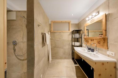 a bathroom with a sink and a shower at "Innsbruck Moments" Kasperhof Appartements in Innsbruck