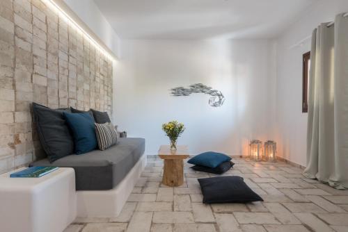 a living room with a couch and a table at Elia Residences Santorini in Karterados