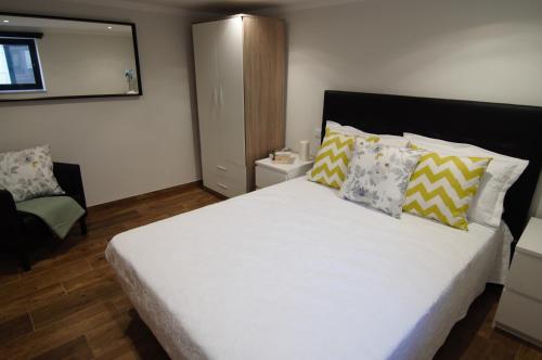 a bedroom with a large white bed with pillows at Angelas - Casa Do Coberto in Vila Praia de Âncora