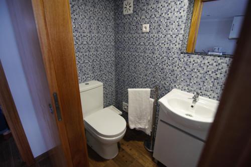 a bathroom with a toilet and a sink at Angelas - Casa Do Coberto in Vila Praia de Âncora