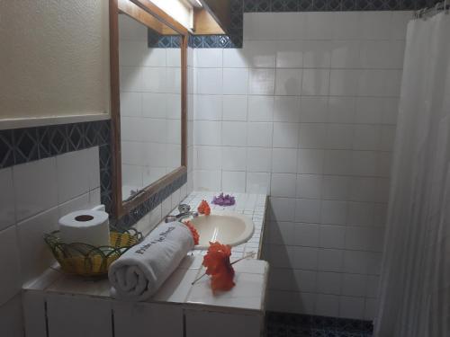 a bathroom with a sink and a mirror at Grand Eastern Hotel in Labasa