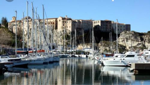 a bunch of boats docked in a marina with buildings at Pousada Romantica in Tropea