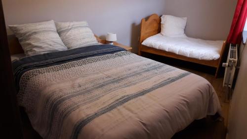 a bedroom with a large bed and a chair at Casa Andres in Malmedy