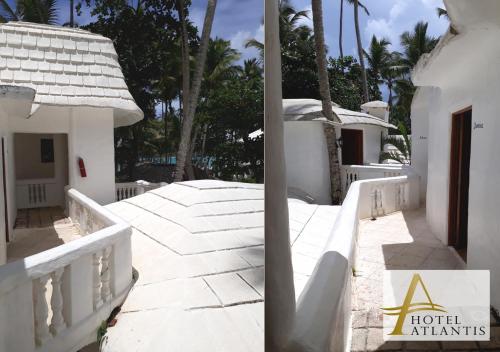a view of a white building with palm trees at Hotel Atlantis in Las Terrenas