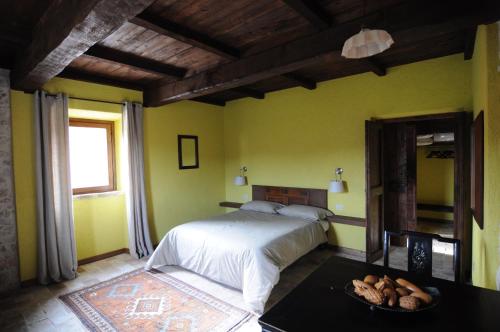 a bedroom with a bed and a bowl of food on a table at Agriturismo Casale Montebello in Monteleone di Spoleto