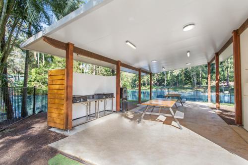 a large screened in porch with a table at Landsborough Holiday Park in Landsborough