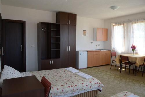 a bedroom with a bed and a kitchen with a table at Apartments Taneski in Ohrid
