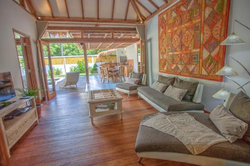 una sala de estar con un sofá y una mesa en Kempas Villa, en Gili Air