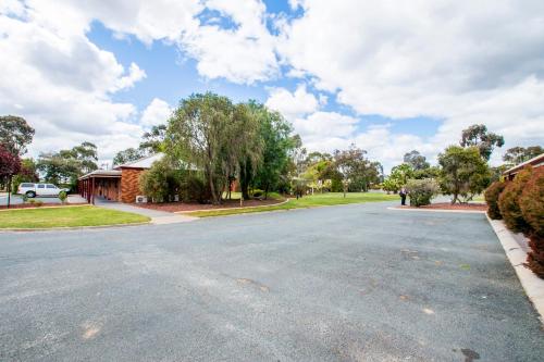 an empty street in front of a house at Sportslander Motor Inn in Moama