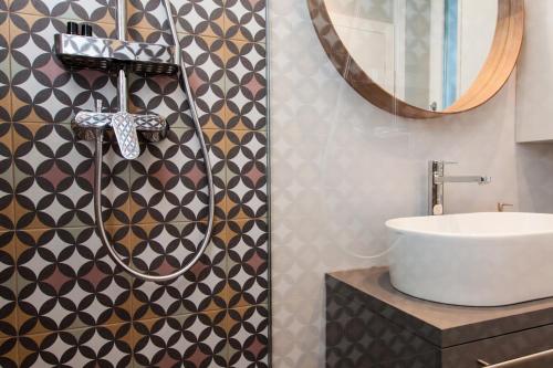 a bathroom with a sink and a mirror at Rooms and Apartments Glossy in Zagreb