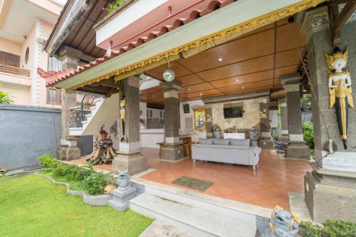 a house with a porch with a couch on a patio at Mudha Bali Villa Sanur 4 Bedrooms in Sanur