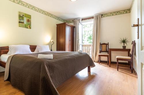 a bedroom with a bed with a blanket on it at Apartmány Jedovnice in Jedovnice