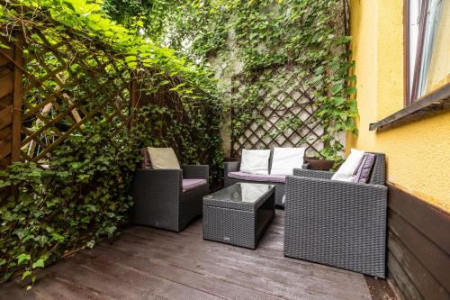 a group of wicker chairs sitting on a patio at Apartmány Jedovnice in Jedovnice