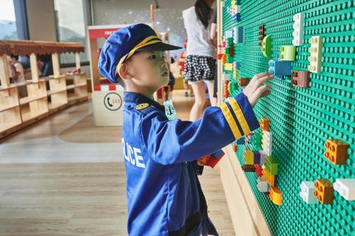 a young boy playing with bricks on a wall at Harbour 10 Hotel in Kaohsiung