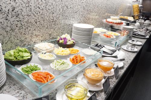 a buffet with several dishes of food on a table at Erian Hotel in Jakarta