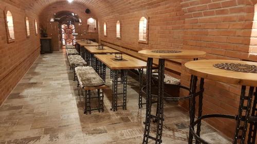 a row of bar stools in a brick room at Penzion U Hada in Velké Pavlovice