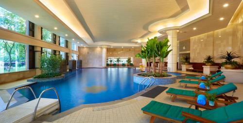 a large swimming pool in a hotel lobby at C&D Resort,Wuyi Mountain in Wuyishan