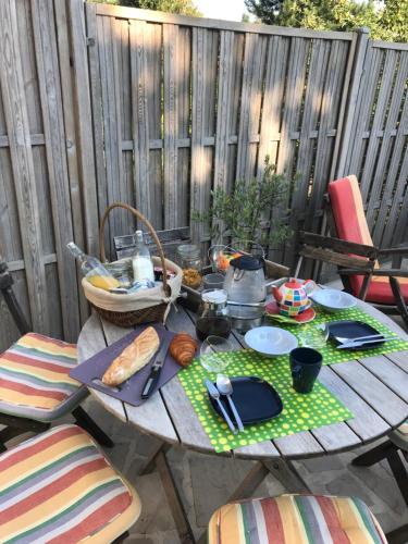 a wooden table with food on it on a patio at le numero 100 in Nancy
