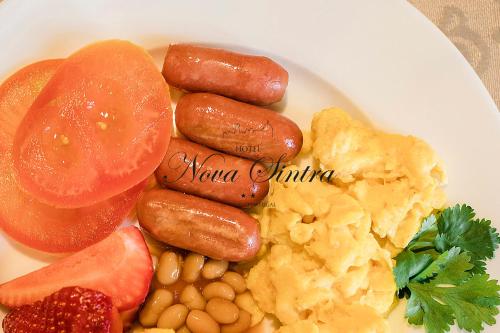 a plate of food including beans, beans, and sausage at Hotel Nova Sintra in Sintra