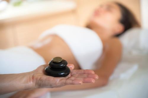 a woman holding a black object in her hand at Val di Luce SPA Resort in Abetone