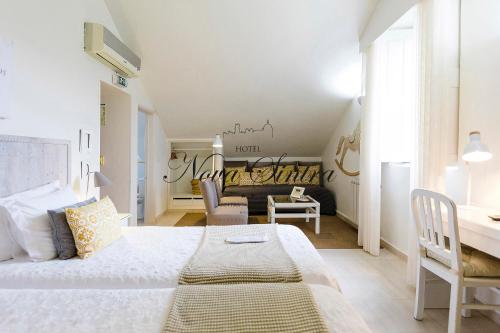 a bedroom with a bed and a desk in a room at Hotel Nova Sintra in Sintra