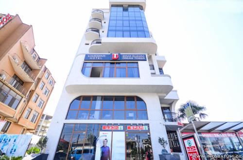 a tall white building with a lot of windows at Dream Tower in Batumi