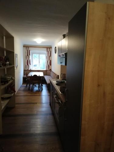 a kitchen with a stove and a table in a room at Amtmannhaus Ferienunterkunft in Irdning