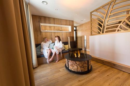 two women sitting on a couch in a room at Hotel Storck in Bad Laer