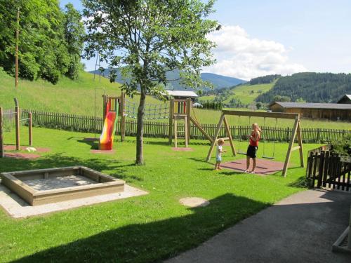 a woman and a child playing in a park at Ferienhaus Waldsicht in Flachau