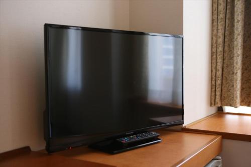 a large flat screen tv sitting on a table at Hotel Hokke Club Hiroshima in Hiroshima