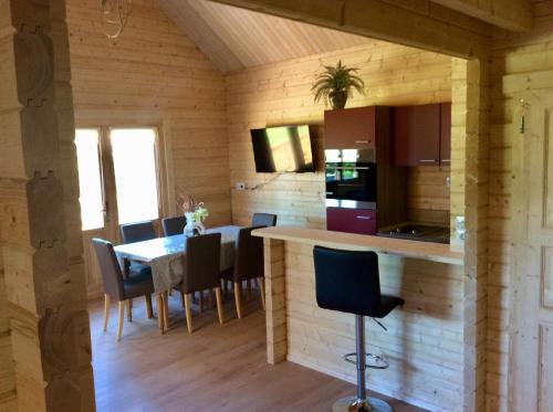 a kitchen and dining room with a table and chairs at Blockhäuser Harzblick in Hohegeiß