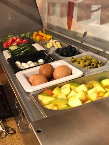 a refrigerator filled with different types of fruits and vegetables at Danubius Hotel Erzsébet City Center in Budapest