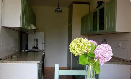 eine Vase voller Blumen in der Küche in der Unterkunft Adelia in Mali Lošinj