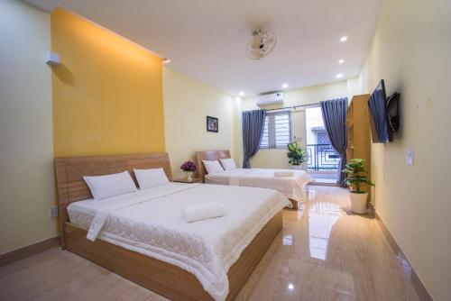 a bedroom with a large bed and a couch at Language Exchange Hostel 1 in Ho Chi Minh City