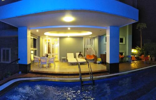 a house with a swimming pool at night at Nancy Sweet Villa in Vung Tau