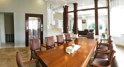 a dining room with a wooden table and chairs at Nancy Sweet Villa in Vung Tau